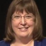 Susanna Widicus Weaver portrait in front of a black background.