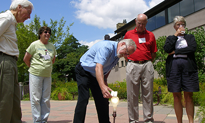 Board of Visitors members gather outside.