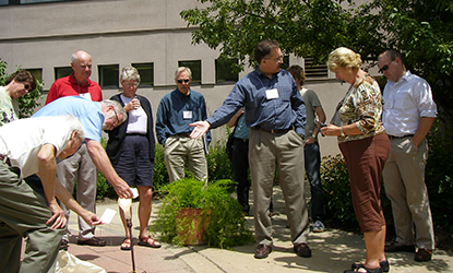 Board of Visitors members gather outside.