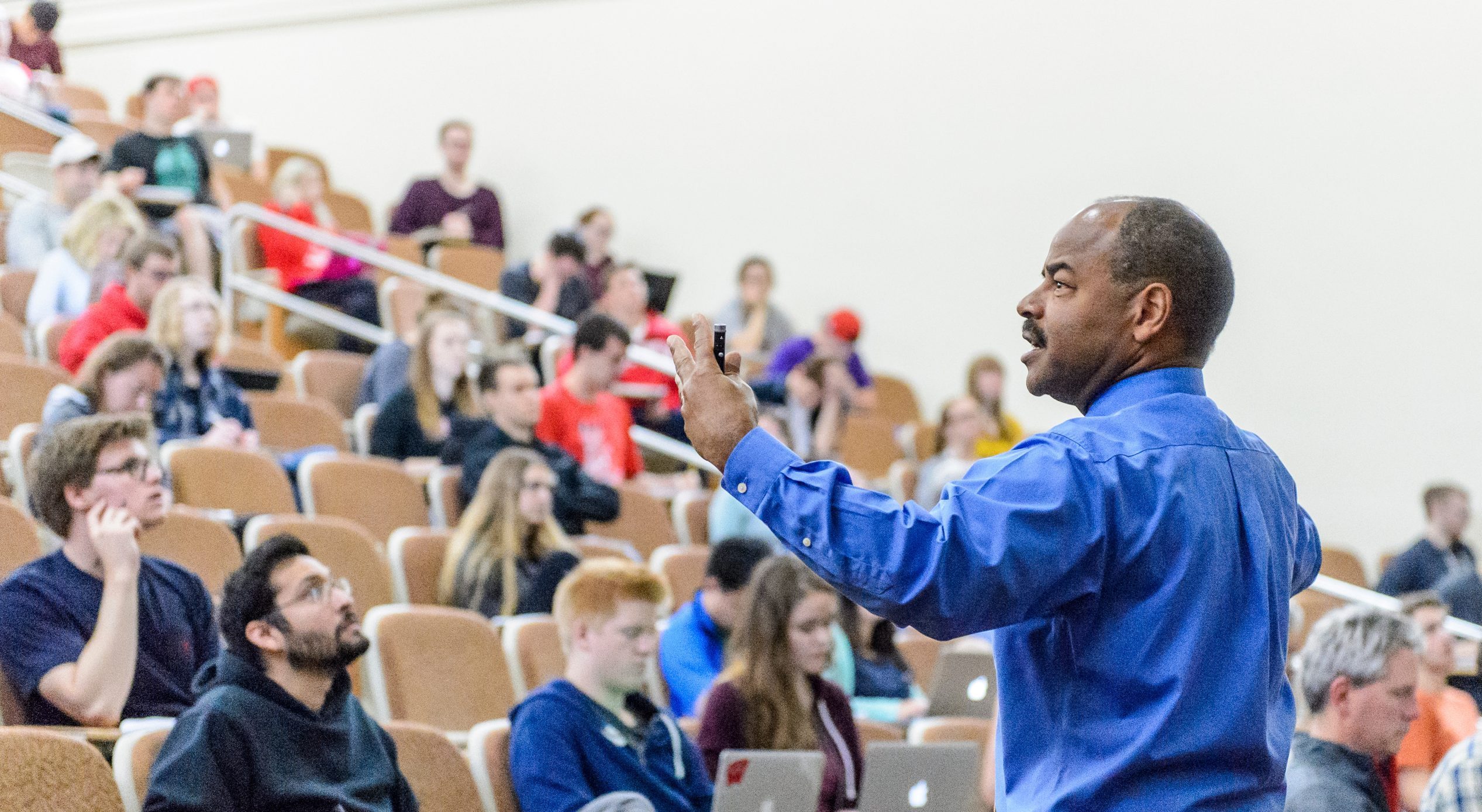Professor and Associate Dean Eric Wilcots addresses a lecture hall in Sterling Hall.