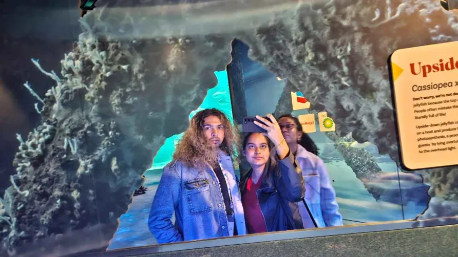 Two RADIAL students pose in front of a mirror to take a selfie.