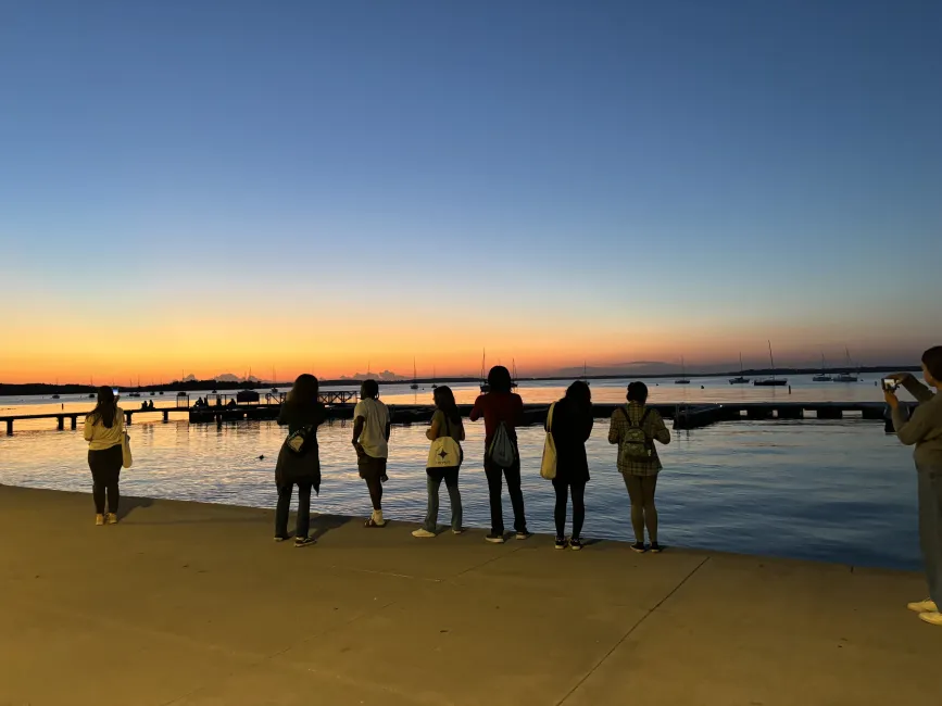 RADIAL students stand and watch the sunset over Lake Mendota.