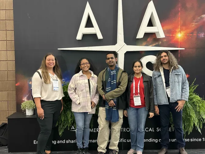 RADIAL students stand in front of the American Astronomical Society sign at a conference.