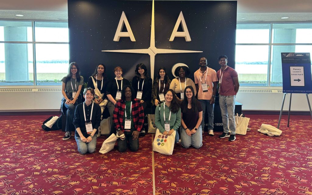 RADIAL student group photo in front of the American Astronomical Society sign.
